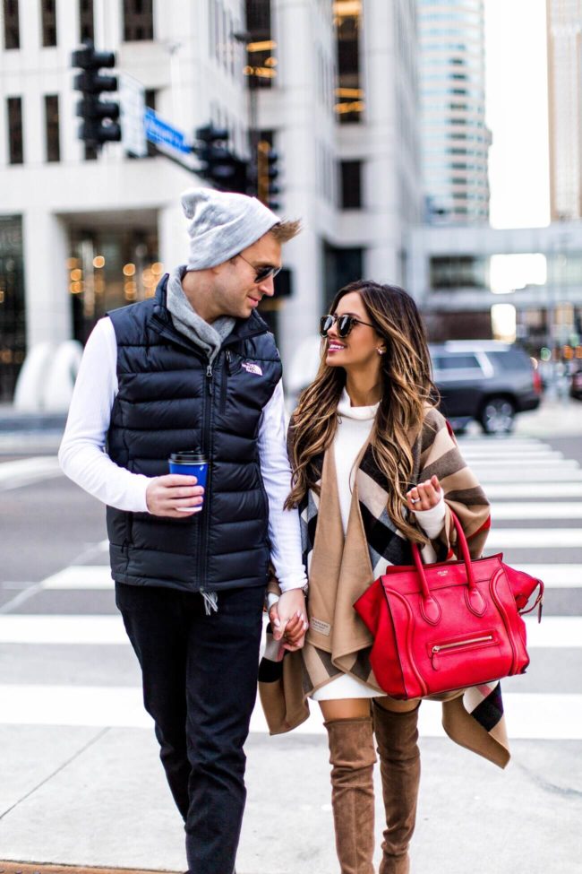 mia mia mine wearing a burberry cape and husband Phil wearing a north face vest