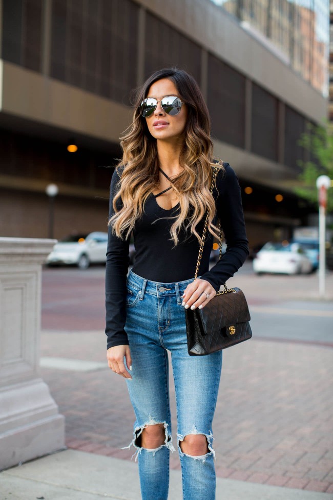 fashion blogger maria vizuete of mia mia mine in a black bodysuit and chanel handbag