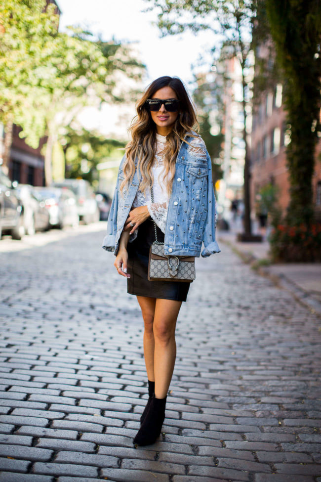 mia mia mine wearing a ripped denim jacket with studs in soho, new york