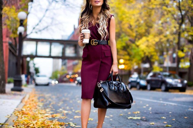 fashion blogger mia mia mine wearing a burgundy sleeveless trench coat from nordstrom