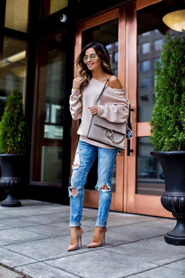 fashion blogger mia mia mine wearing a pink sweater from free people