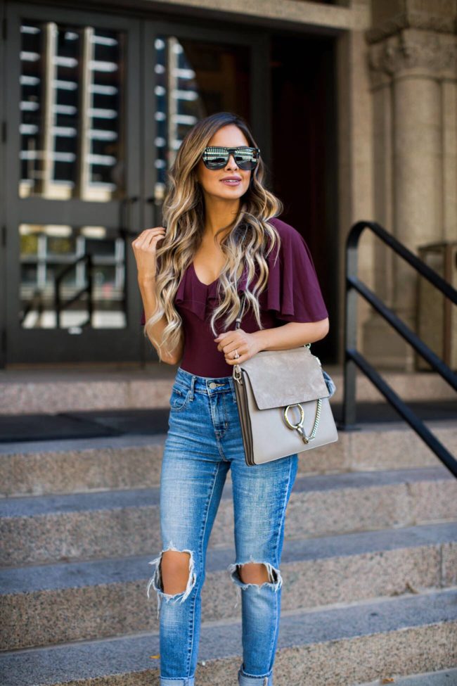 fashion blogger mia mia mine carrying a chloe faye bag in motty grey color