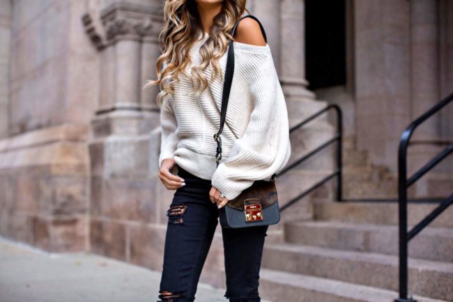 fashion blogger mia mia mine wearing an off-the-shoulder sweater from topshop