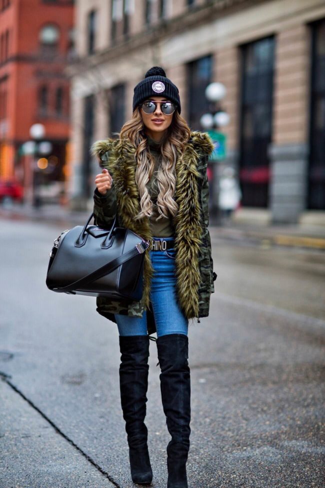 fashion blogger mia mia mine wearing a camo coat from nastygal, a herschel beanie and a givenchy antigona bag