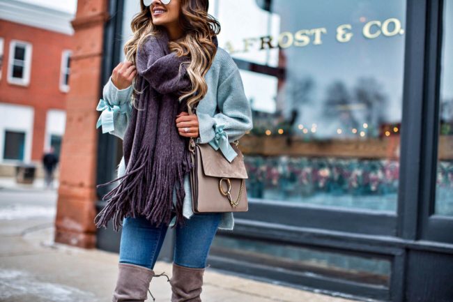 fashion blogger mia mia mine carrying a chloe faye bag and a tie cuff sweater by topshop 