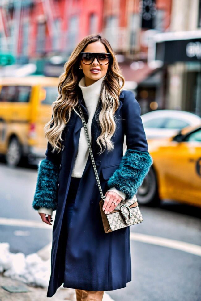 Fashion blogger mia mia mine wearing a winter coat from asos at new york fashion week