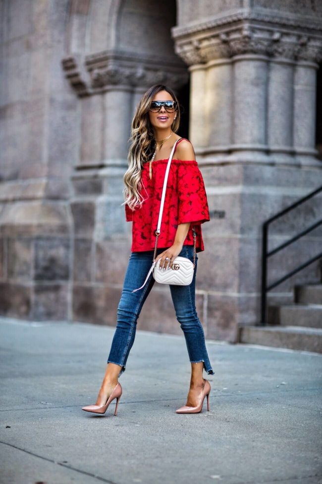 fashion blogger mia mia mine wearing a red lace top and gucci marmont bag with rag & bone capri jeans