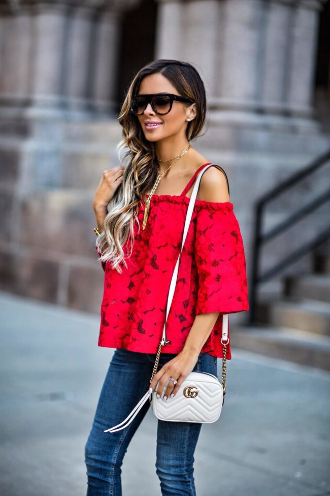 fashion blogger mia mia mine wearing a red lace top and a vanessa mooney necklace from shopbop
