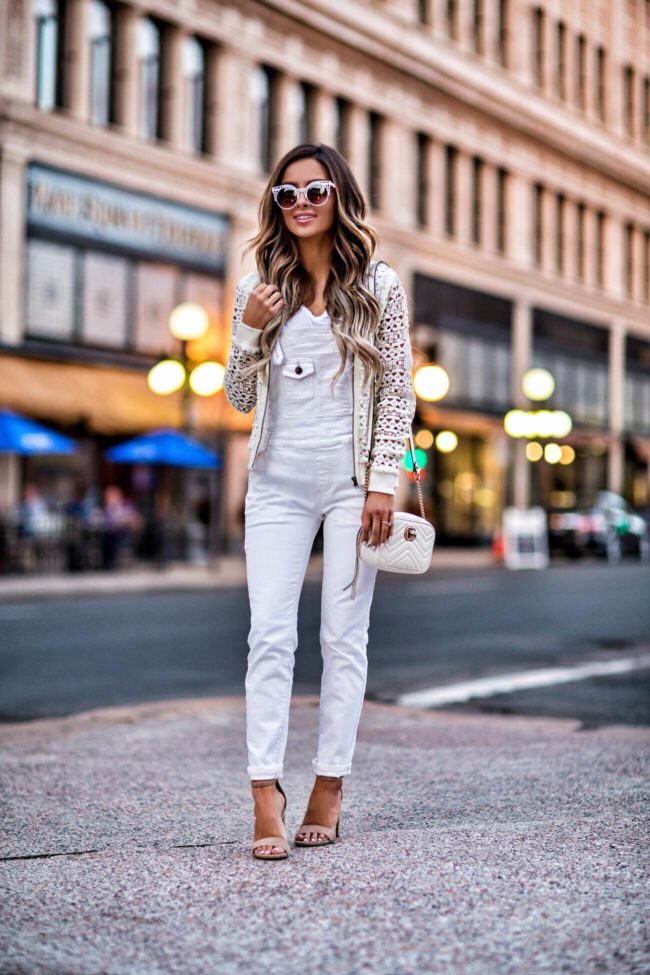 fashion blogger mia mia mine wearing white overalls and a white gucci bag 