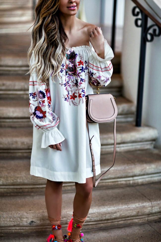 fashion blogger mia mia mine wearing an embroidered off-the-shoulder dress and a chloe nile bag in maui