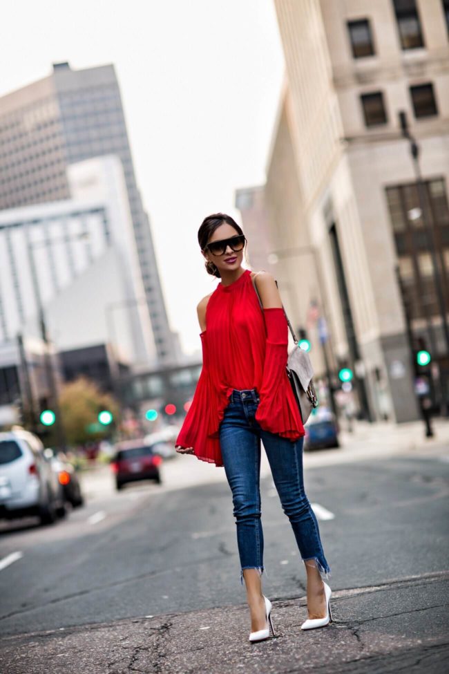 Fashion blogger wearing Style Mafia red op with pleats, Rag & Bone Step Hem jeans, Jules Smith Hoop Earrings, Chloe Faye bag, Celine sunglasses