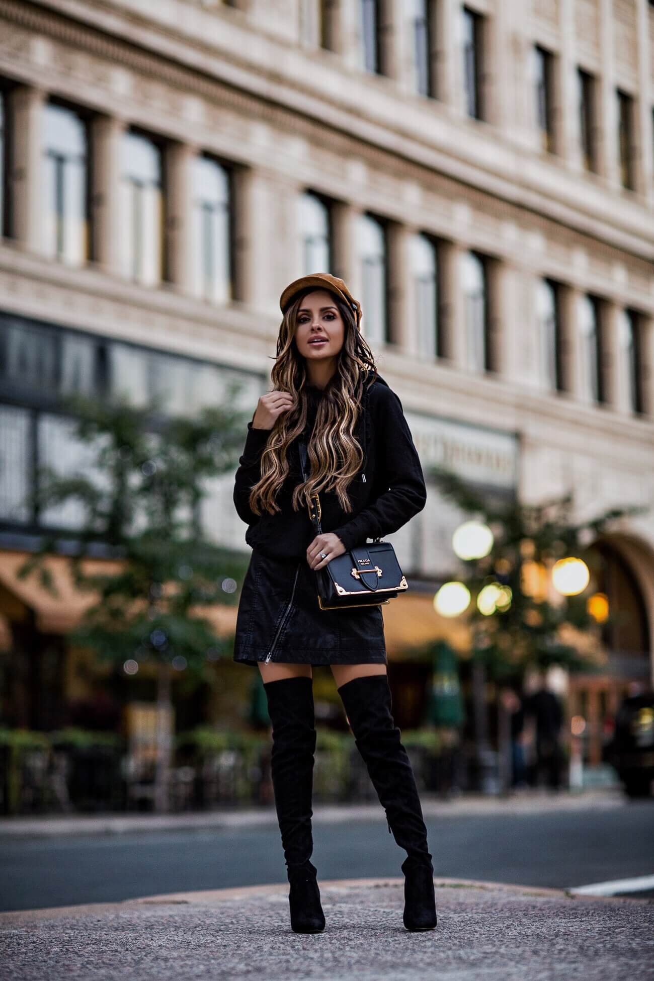 fashion blogger mia mia mine wearing a black leather mini skirt and a prada cahier bag