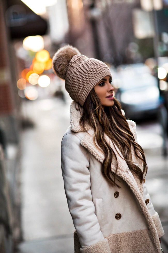 Fashion blogger Mia Mia Mine wearing a pom beanie