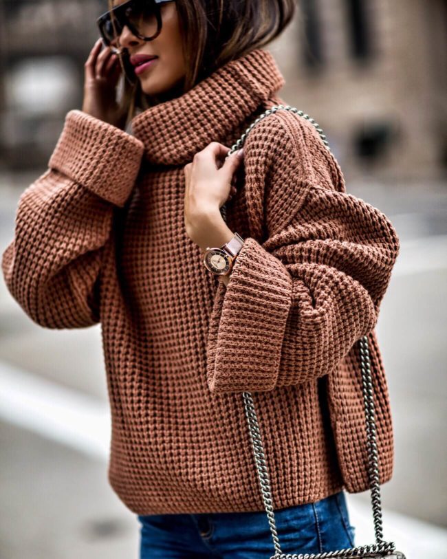mia mia mine wearing a chunky knit sweater and kenneth cole watch