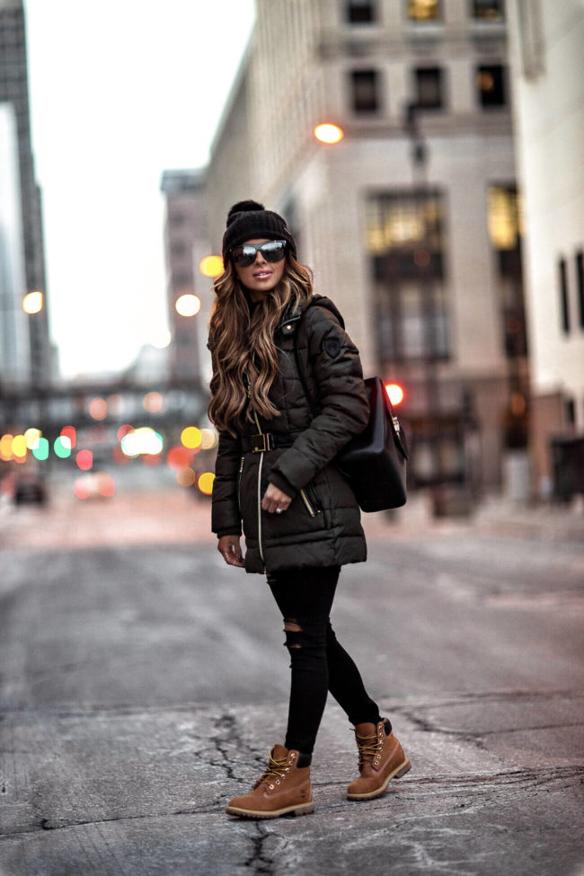 fashion blogger mia mia mine wearing a green parka from macy's for winter
