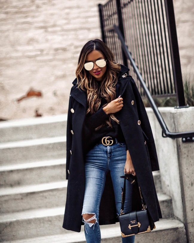 mia mia mine wearing a black coat with gold buttons from Macy's