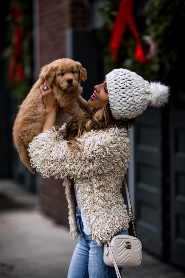fashion blogger mia mia mine wearing a shag loop cardigan from bloomingdale's and a pom pom beanie