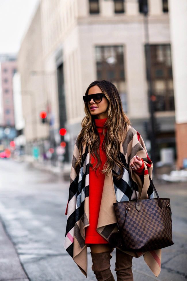 mia mia mine wearing a burberry cape and louis vuitton bag