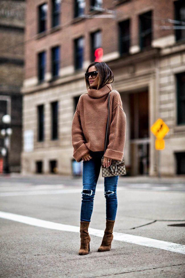 mia mia mine wearing a chunky knit sweater and a gucci dionysus bag