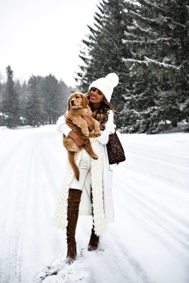 fashion blogger mia mia mine wearing a white duster jacker and a free people beanie
