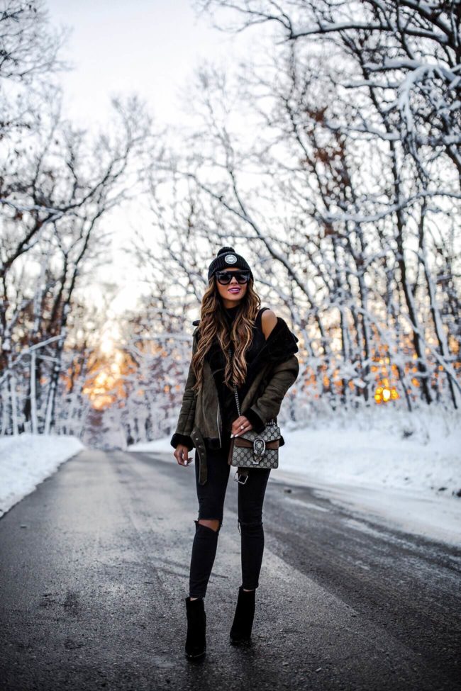 fashion blogger mia mia mine wearing a herschel beanie and a gucci dionysus bag