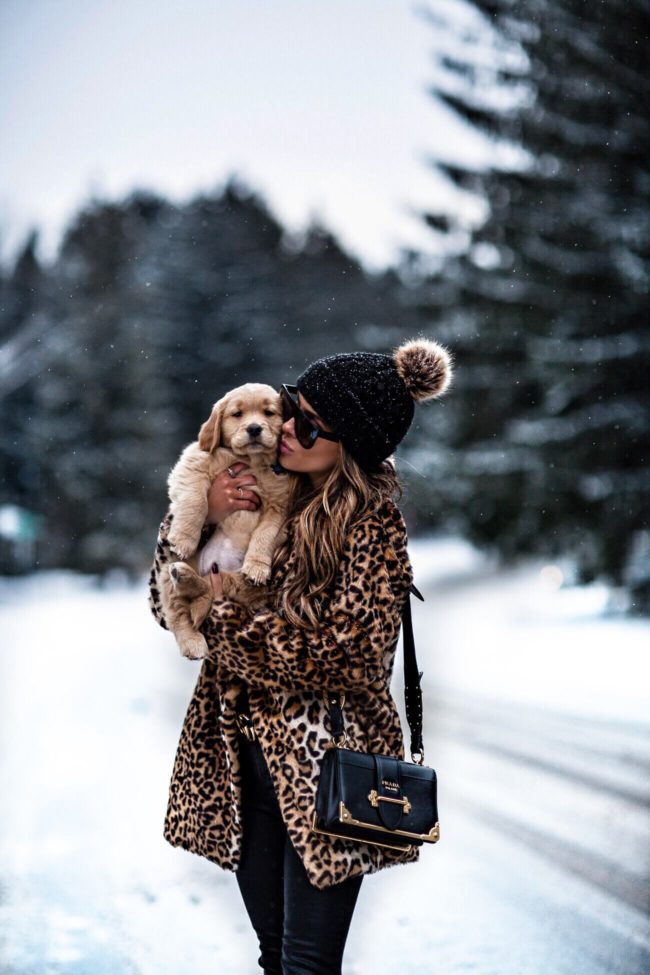 fashion blogger mia mia mine wearing a prada cahier bag and pom pom beanie from asos