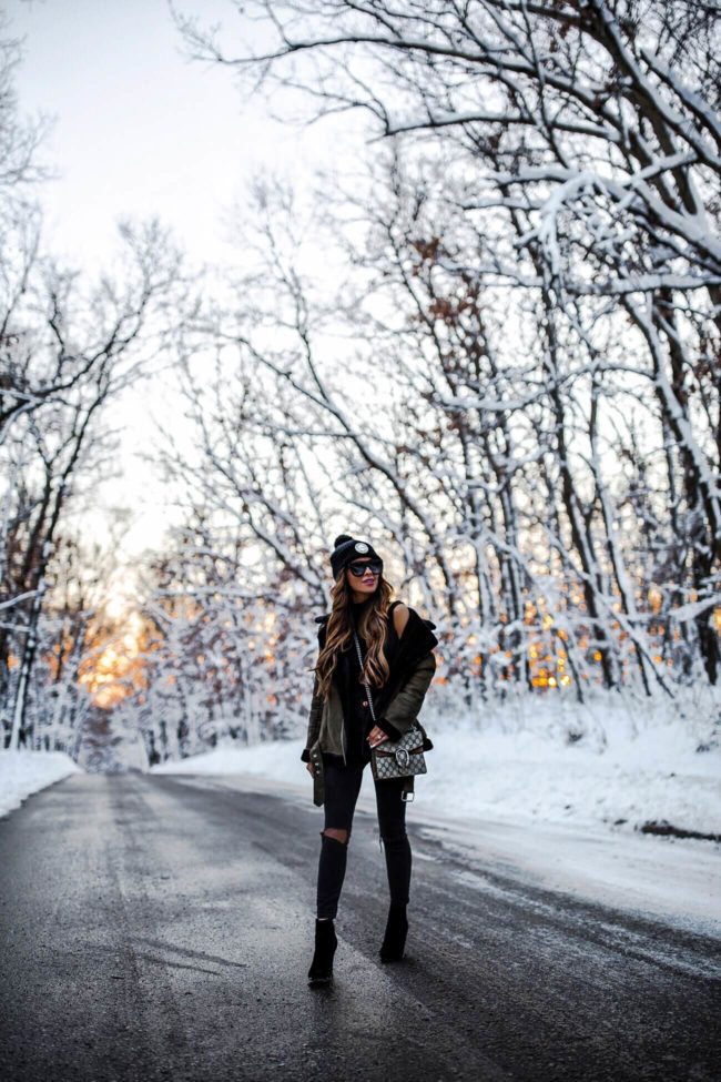 mia mia mine in a snowy field wearing a winter outfit from shopbop