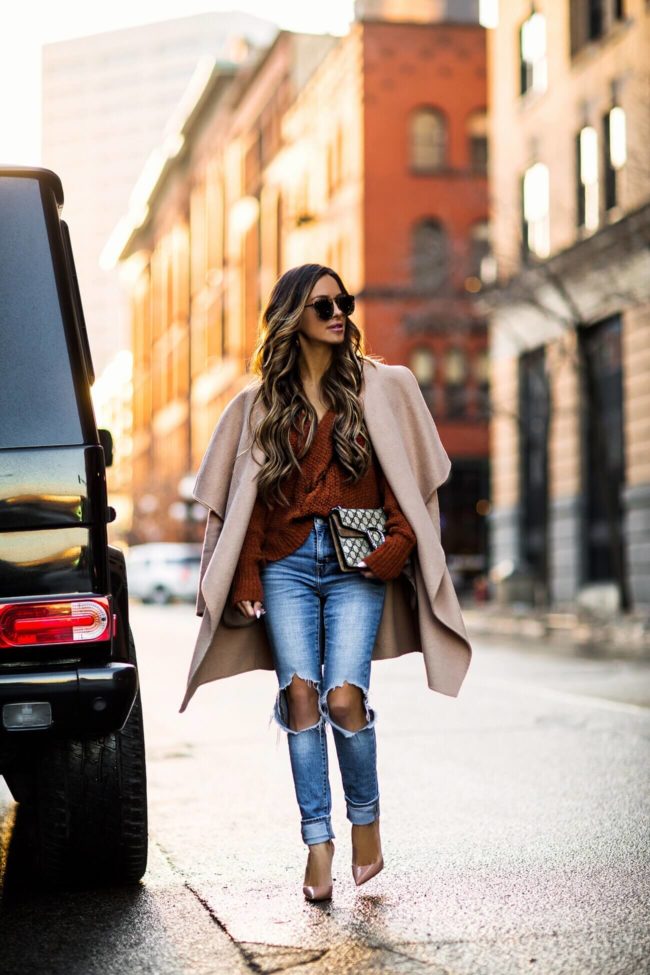 fashion blogger mia mia mine wearing a camel coat and levi's denim