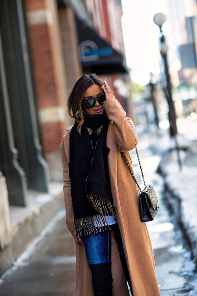 mia mia mine wearing a camel coat and burberry scarf