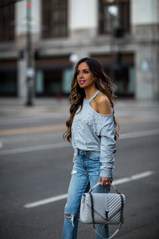 fashion blogger mia mia mine wearing a gray olivia culpo sweatshirt and grlfrnd denim from revolve