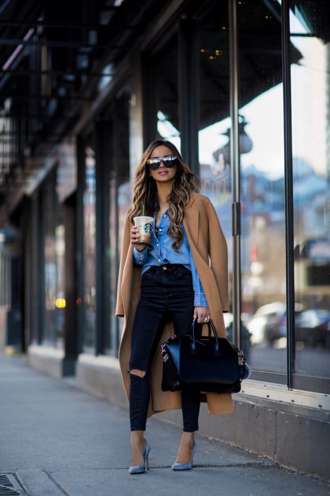 fashion blogger mia mia mine wearing a camel coat and a j. crew denim shirt