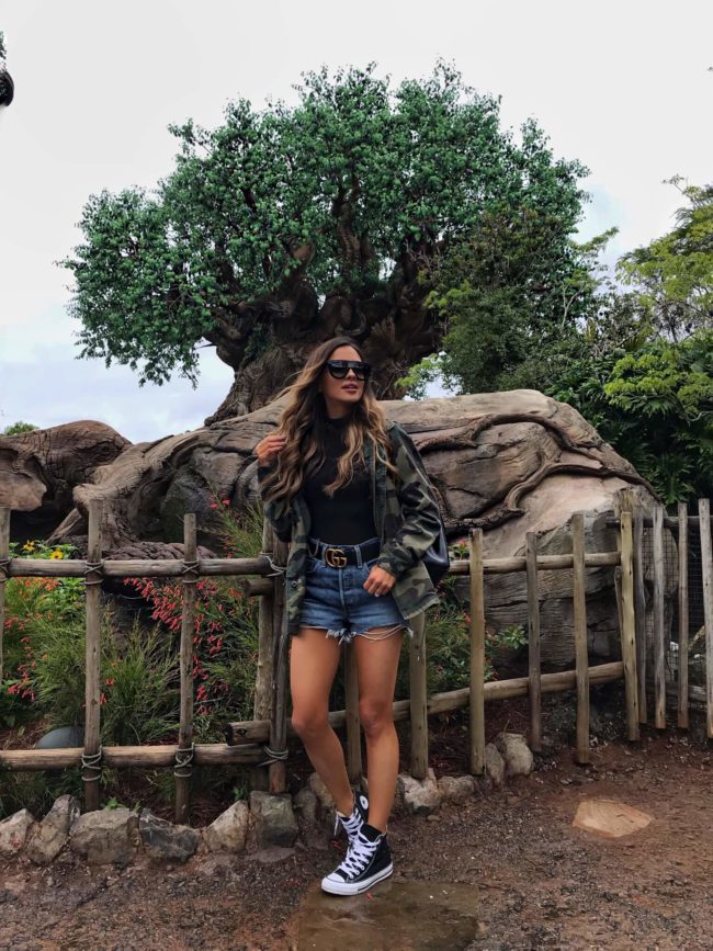 fashion blogger mia mia mine wearing a camo jacket and converse sneakers