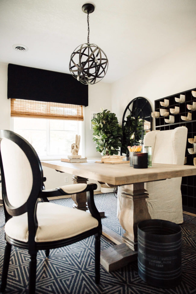 home blogger mia mia mine's home office featuring a trestle table from home depot and an rh wingback chair