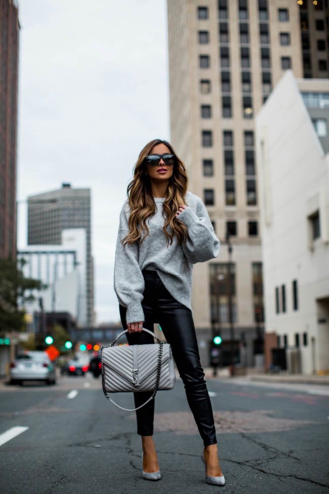 fashion blogger mia mia mine wearing a grey sweater and faux leather pants from shopbop