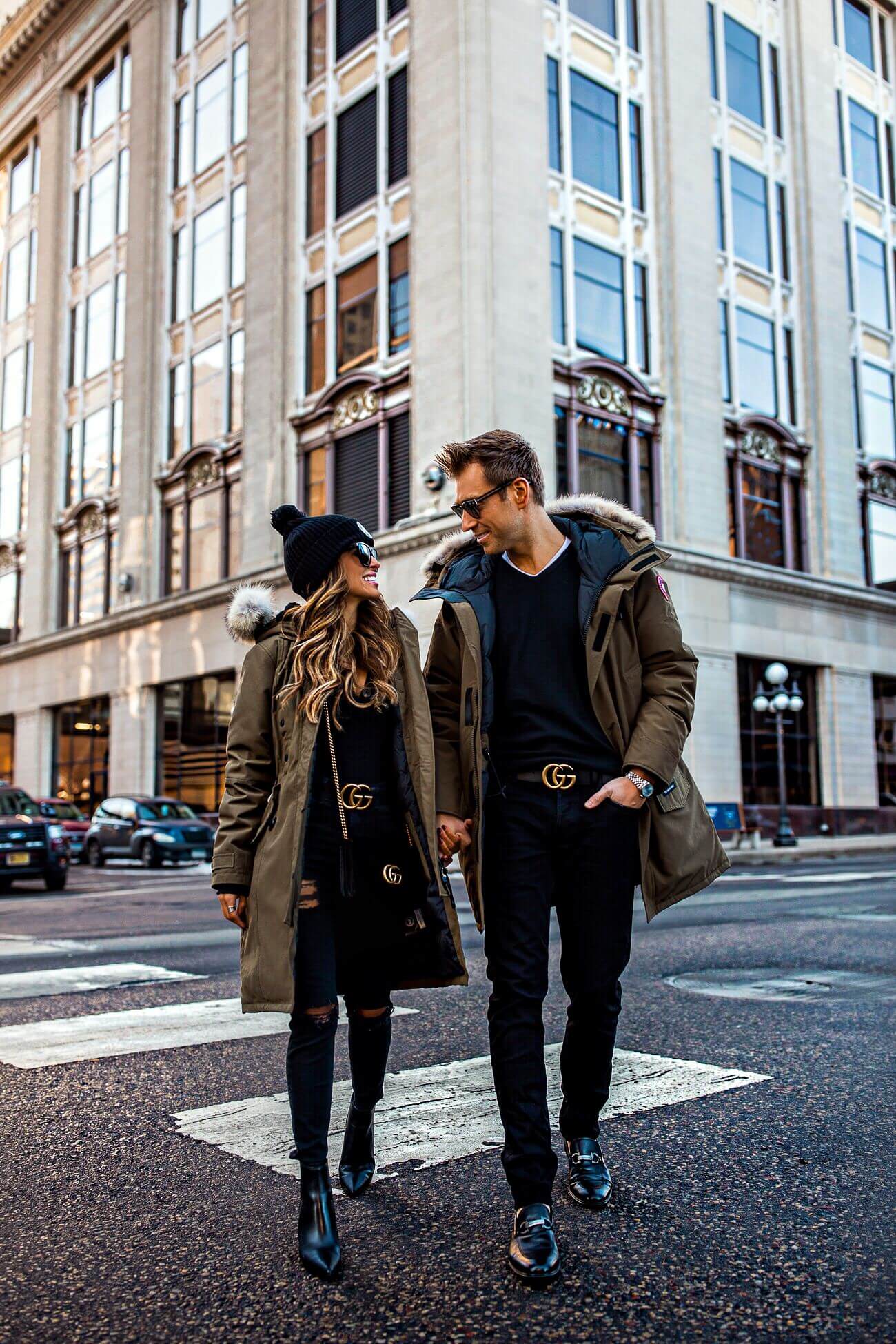 fashion blogger mia mia mine wearing a canada goose jacket and a gucci belt wtih husband phil
