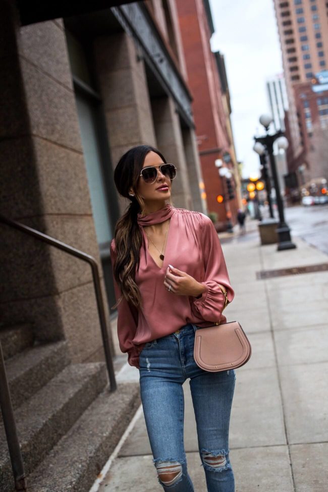 fashion blogger mia mia mine wearing a pink blouse from intermix and frame denim
