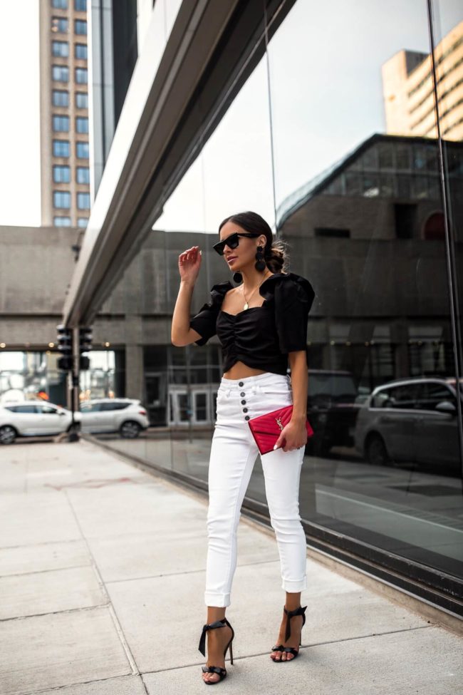 fashion blogger mia mia mine wearing a black crop top and white denim from vici dolld