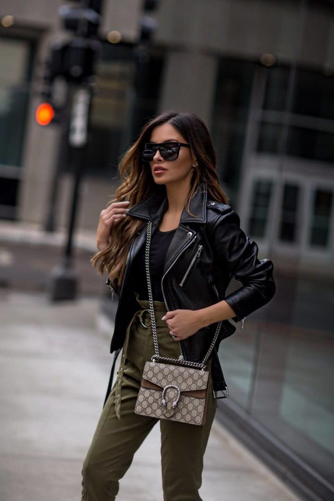 fashion blogger mia mia mine wearing olive high waist pants and a gucci dionysus bag