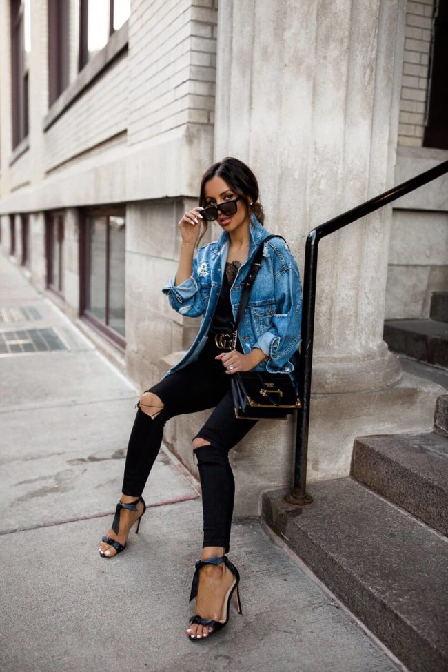 fashion blogger mia mia mine wearing a denim jacket and a prada cahier bag