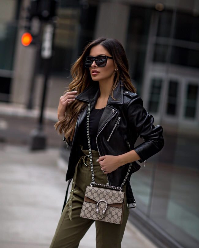 fashion blogger mia mia mine wearing olive high waist pants and a gucci dionysus bag