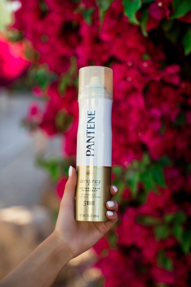 Fashion blogger Mia Mia Mine holding Patene airspray
