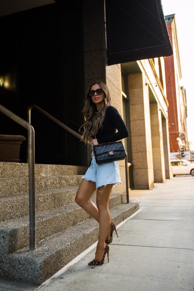 fashion blogger mia mia mine wearing a black bodysuit and a denim skirt