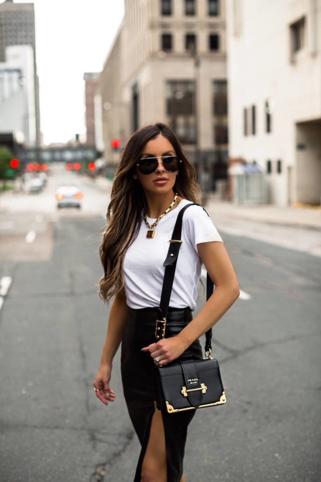 fashion blogger mia mia mine wearing a white tee and a revolve faux leather skirt with a dior lucky locket necklace 2019