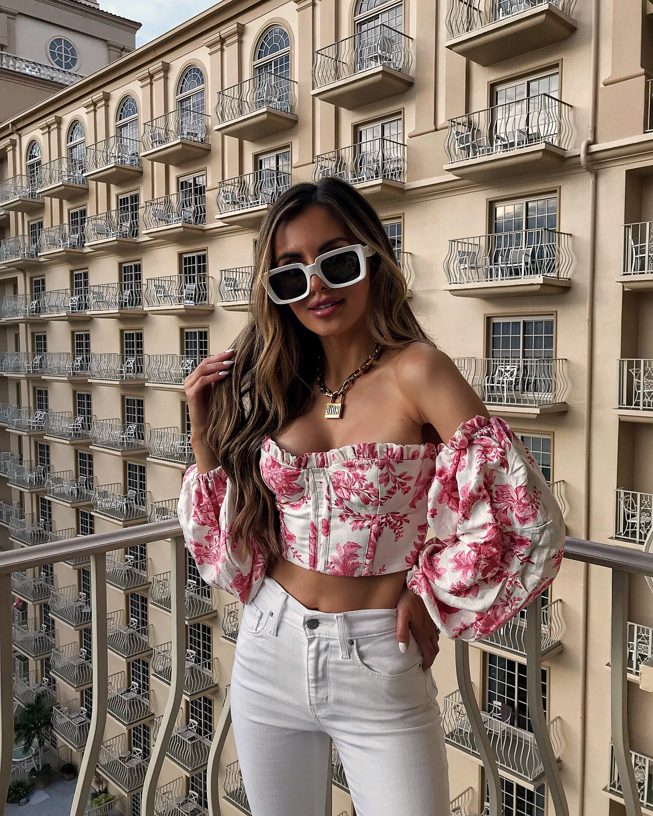 fashion blogger mia mia mine wearing a pink top from revolve in naples florida at the ritz-carlton