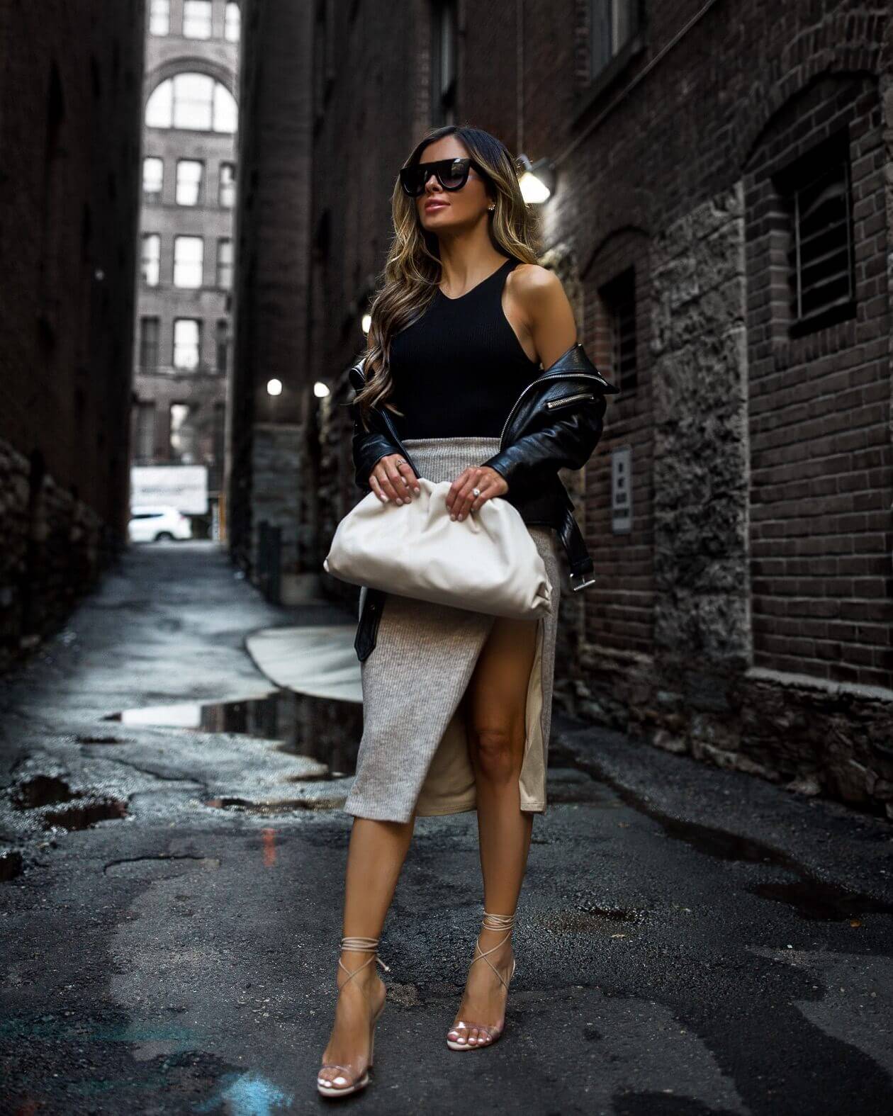 fashion blogger mia mia mine wearing a bottega veneta bag and a black bodysuit