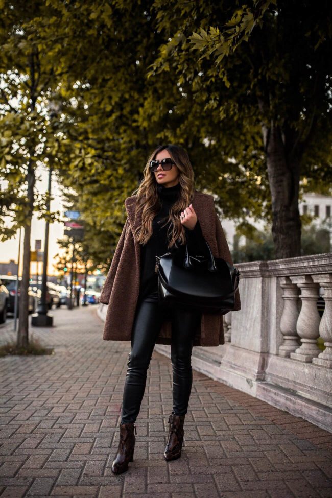 fashion blogger mia mia mine wearing an oversized sweater and snakeskin booties from walmart
