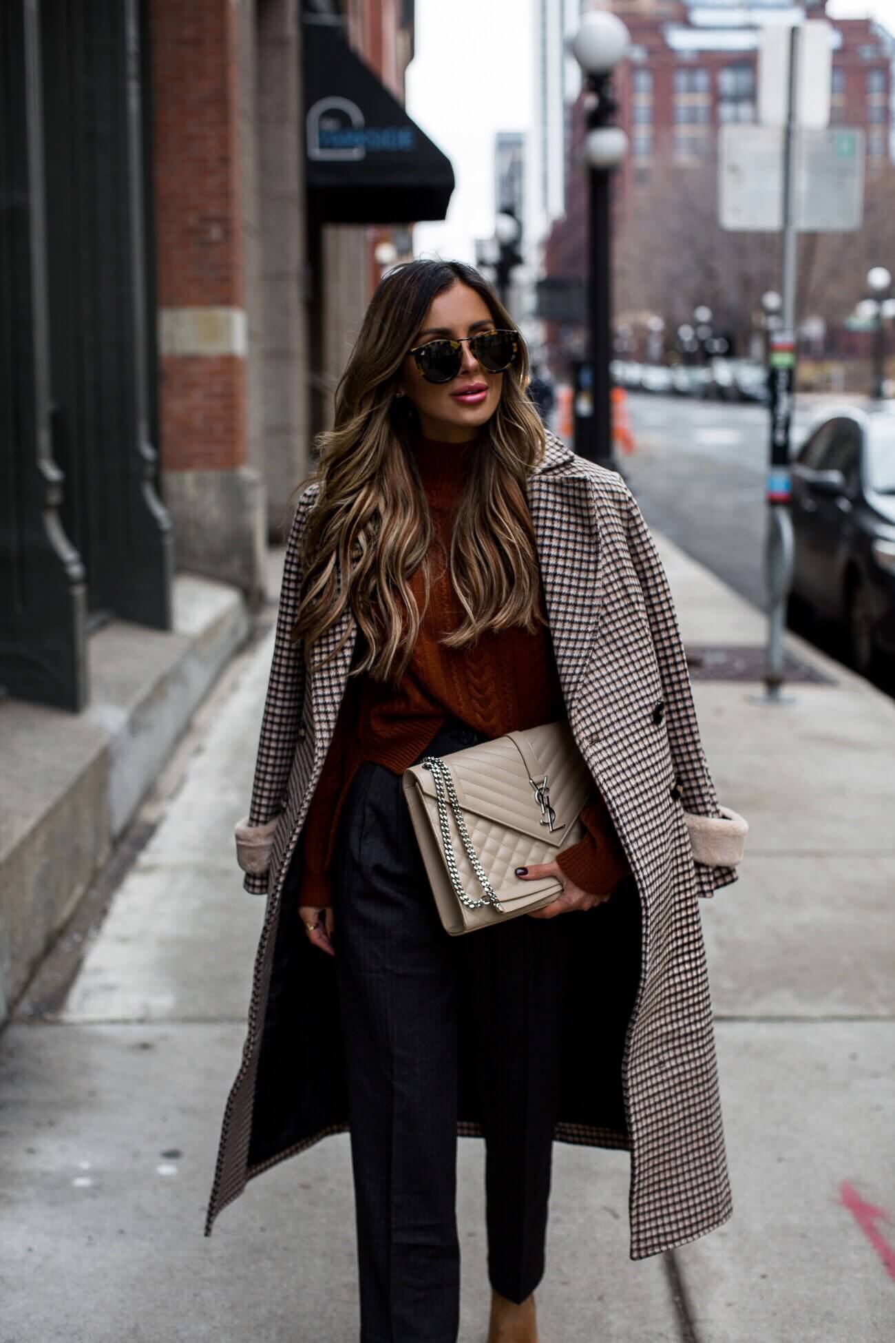 fashion blogger mia mia mine wearing a rust orange turtleneck sweater and trousers from petite studio