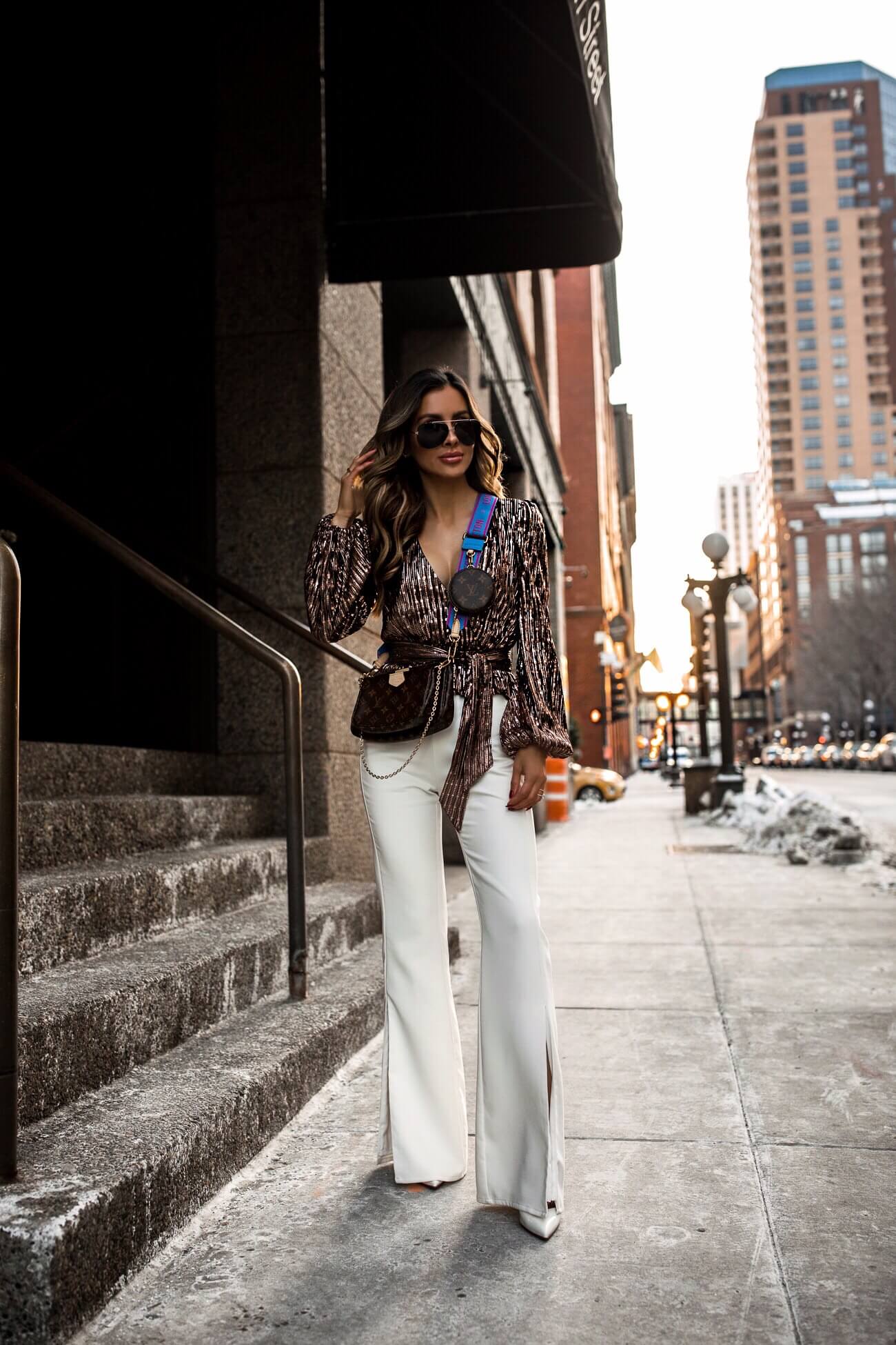 fashion blogger wearing a louis vuitton multi pochette with limited edition blue strap from stockx