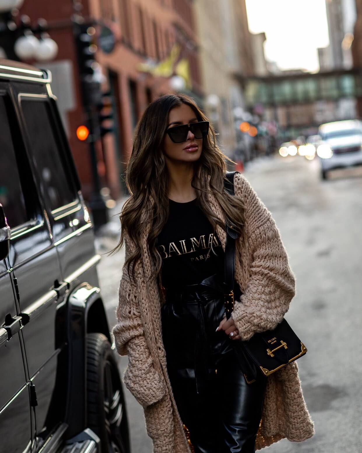 fashion blogger mia mia mine wearing a chunky knit cardigan from revolve with a balmain tee