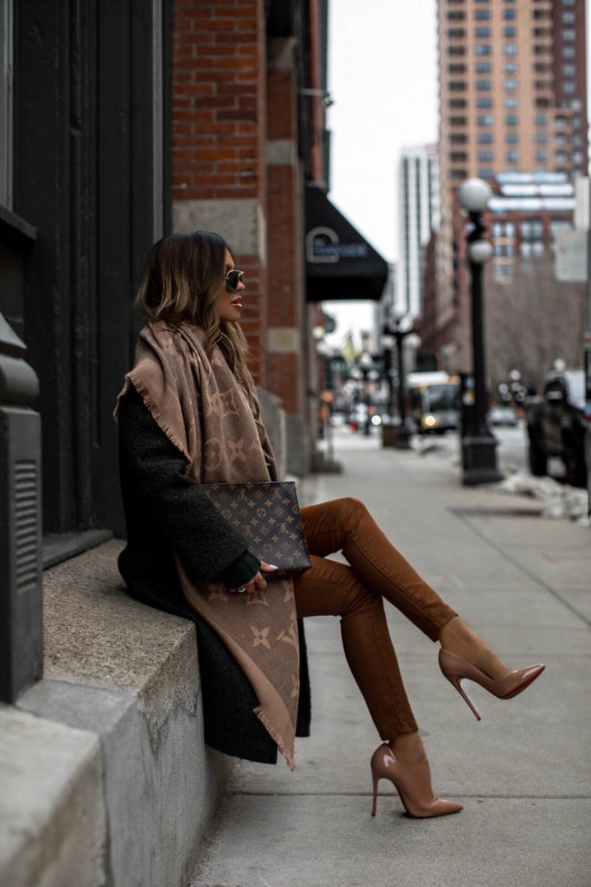 fashion blogger mia mia mine wearing a green coat and a louis vuitton scarf for winter